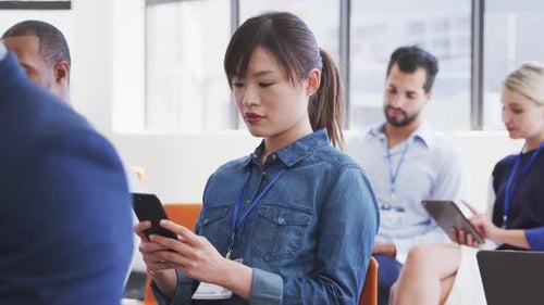 Conference Attendees Using Technology Indoors During Meeting