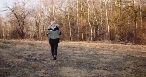 Woman Using a Map for Travel in Nature