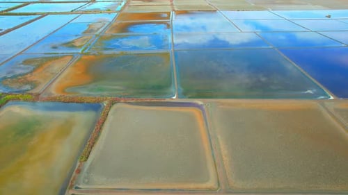 An aerial view from a drone flying over a salt fields, salt production.