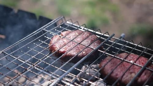 Beef Burgers Cutlets are Roasting on the Charcoal Barbecue Grill