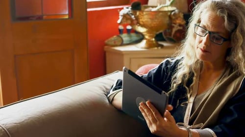 Senior Woman Relaxing at Home with Tablet