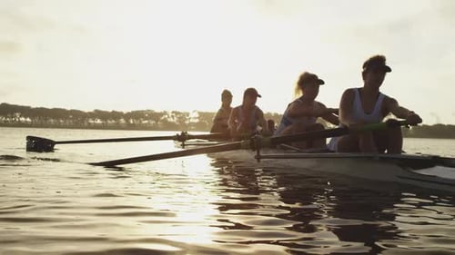 Female rowing team training on a river