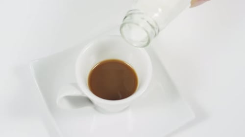 Milk Being Poured into Coffee Mug in Close-Up