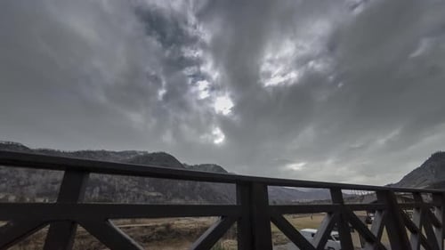 Timelapse of Wooden Fence on High Terrace at Mountain Landscape with Clouds, Horizontal Slider