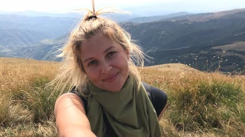 Female hiker takes selfies on mountain peak close-up 4K 2160p 30fps UltraHD footage - Pretty woman f