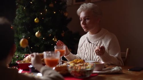 Closeup View From Back of Unrecognizable Little Child Boy to Happy Young Woman Eating Ant Chatting