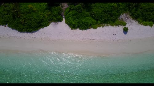 Aerial drone shot landscape of idyllic island beach vacation by shallow sea with white sand backgrou