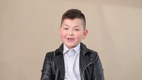 Smiling Boy Talking Against Neutral Background