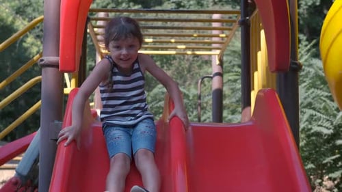 Child Slide Down on Playground