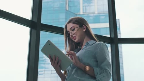 Businesswoman Using Tablet Device in Modern Office