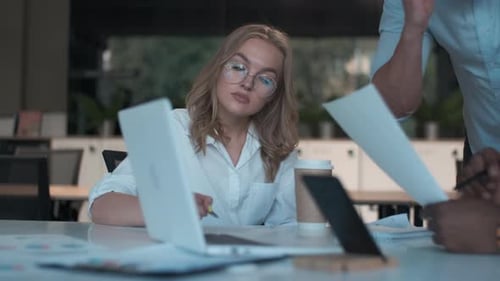 Business Meeting: Woman Working at Laptop With Colleagues