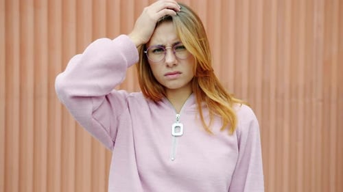 Worried Woman Holding Head in Urban Environment