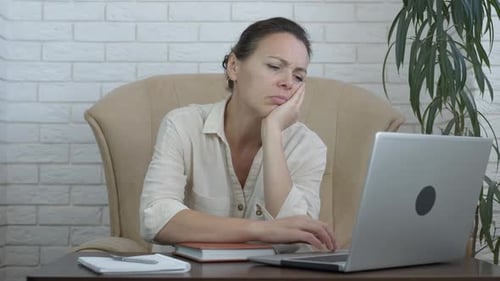 Sleepy freelancer by computer.