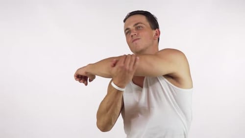 Young Man with Muscular Athletic Body Warming Up Before Workout