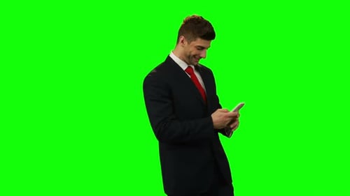 Smiling Businessman Using Phone on Green Screen