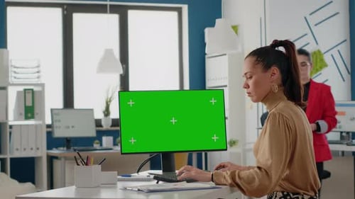 Business Women Using Isolated Green Screen on Monitor