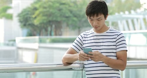 Man using smart phone in city