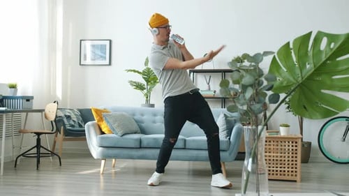 Adult Dances with Remote in Bright Home Interior