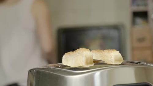 Bread Slices Placed Into Toaster for Breakfast