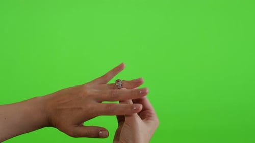 Trying silver ring with red stone on tower in front of green screen display 4K 2160p UltraHD footage