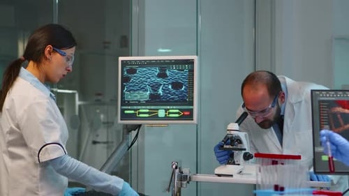 Scientists Working in Laboratory Analyzing Data