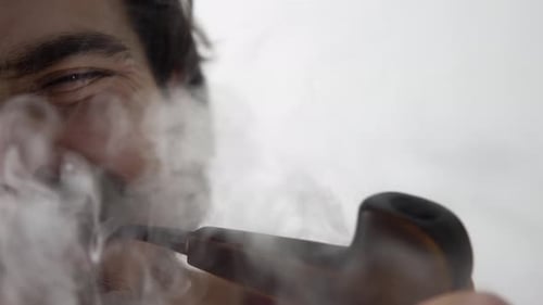 biting cigarette Grinning Man Smoking and Biting a Tobacco Pipe biting cigarette Grinning Man Smoking and Biting a Tobacco Pipe