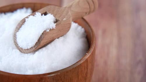 Bowl of White Sugar with Wooden Spoon Close-Up