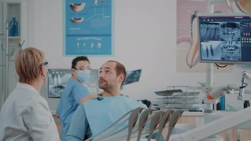 Dental Patient Examined by Dentist with X-rays