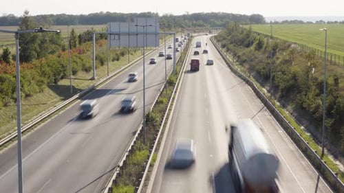 Cars and Trucks Drive on a Busy Highway in a Rural Area Time Lapse Top View