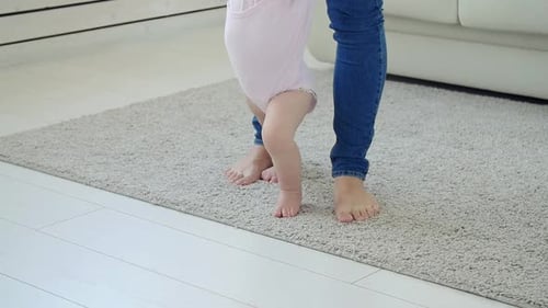 Baby Learning to Walk with Caregiver at Home