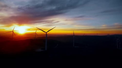 Wind Turbines Silhouetted at Colorful Sunrise