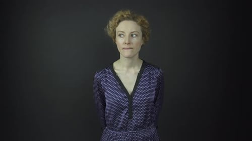 Woman Poses in Studio in Front of Gray Background