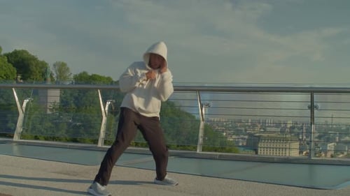 Young Adult Boxing on Bridge Overlooking City