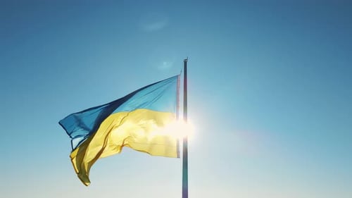 Ukrainian Flag Waving Proudly against Blue Sky
