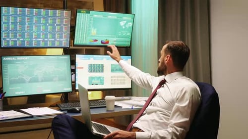 Stock Market Broker with Suit and Tie Typing on Laptop