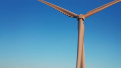 An Aerial View of a Windmill Against the Blue Sky During Sunset