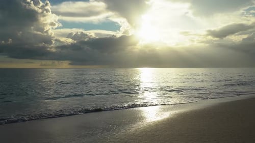 Sunset On The Sea Beach Where The Waves Beat Against The Sand