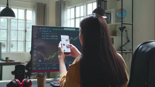 Woman Trader With Financial Stock Market Charts On Desktop Computer And Shopping Online On Mobile