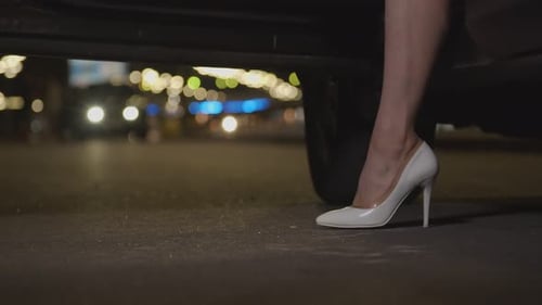 Woman in Heels Exiting Car at Night