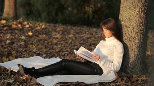 Girl Reading a Book in Park Woman