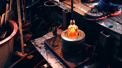 Glassblowing Shaping Molten Glass in Workshop