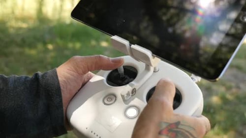 Hands Operating Drone Controller Device in Nature