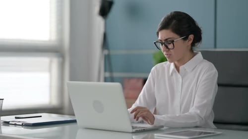 Indian Businesswoman having Wrist Pain while using Laptop in Office
