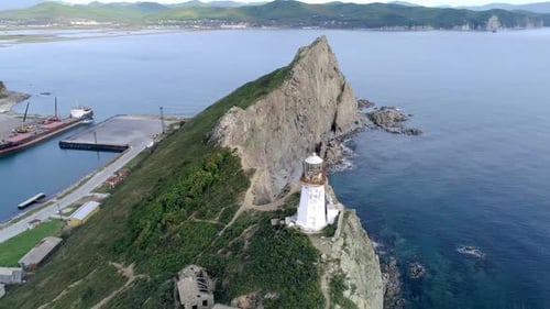 Aerial Orbital View of an Old Lighthouse on the Cliff on Pacific Coast