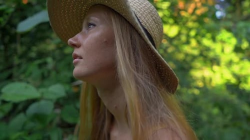 Super Slowmotion Shot of a Young Woman in a Yellow Dress Walking During Sunset at the Campuhan Ridge