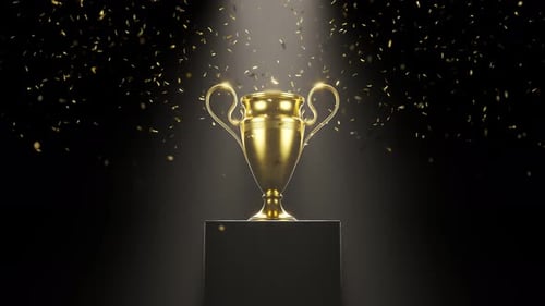 Golden metallic trophy cup on the platform. Award for a winner. Falling confetti