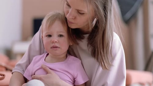 Mother and Child Embrace Indoors in Gentle Close-Up