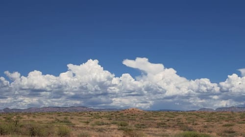 Dramatic Cloudscape Over Arid Desert Landscape