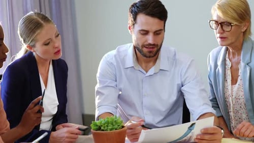 Business Team Discussing Document at Conference Table