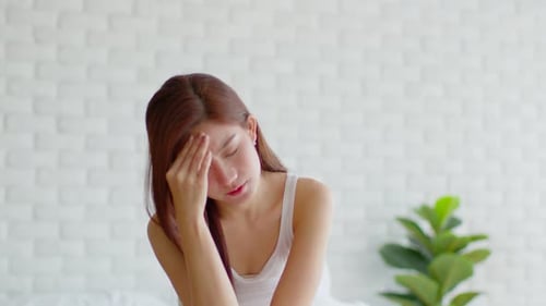 Young Woman Massaging Temples Due to Headache